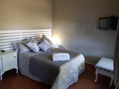 a bedroom with a bed with two pillows on it at El-Ruze in Baviaanspoort
