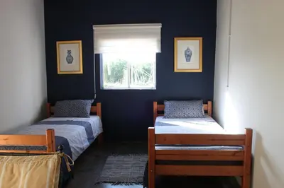 two beds in a room with a window at Rustic Country Cottage in White River