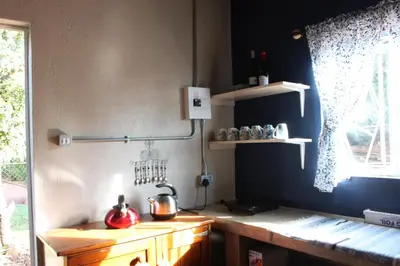 a kitchen with a wooden counter and a blue wall at Rustic Country Cottage in White River