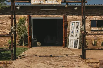 a brick building with a garage with a door at Buffalo Ranch Game Lodge in Groblersdal