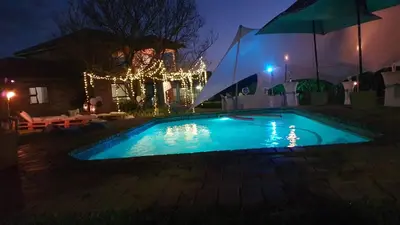 a swimming pool in a yard at night at Buffalo Ranch Game Lodge in Groblersdal