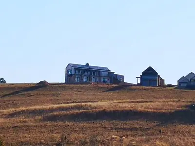 a large house on top of a hill at Highland Gate House 1023 in Dullstroom