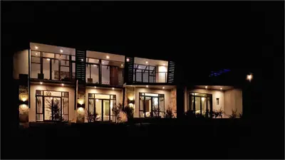 a lit up building at night with lights at Highland Gate House 1023 in Dullstroom