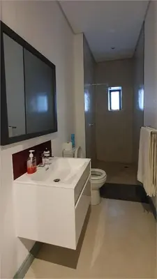 a bathroom with a white sink and a toilet at Highland Gate House 1023 in Dullstroom