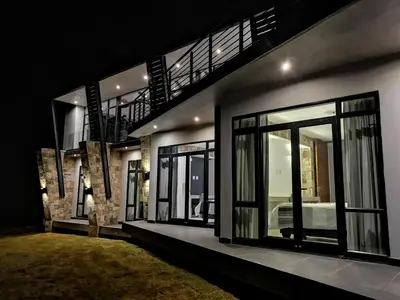 a house with glass windows and a bed in it at Highland Gate House 1023 in Dullstroom