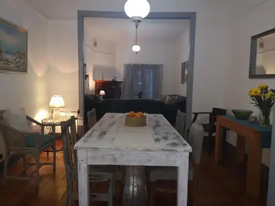a living room with a table with a bowl of fruit on it at Windsor Cottage in Barberton