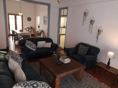 a living room with a couch and a table at Windsor Cottage in Barberton