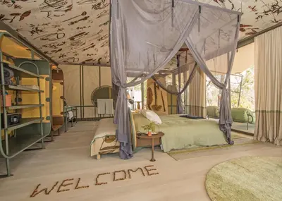 a bedroom with a bed with a canopy at Saseka Tented Camp in Hoedspruit