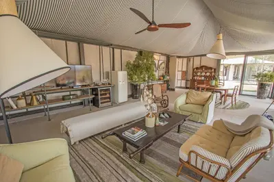 a living room filled with furniture and a ceiling fan at Saseka Tented Camp in Hoedspruit