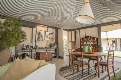 a living room with a table and a couch at Saseka Tented Camp in Hoedspruit