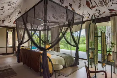 a bedroom with a canopy bed and a window at Saseka Tented Camp in Hoedspruit