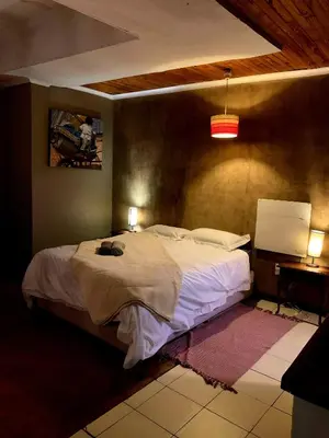 a bedroom with a large bed in a room at The Farm in Hartbeespoort