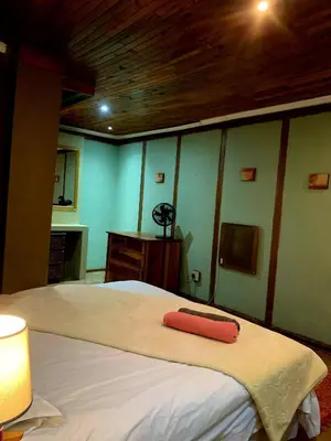 a bedroom with a bed with a red towel on it at The Farm in Hartbeespoort