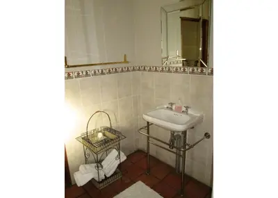 a bathroom with a sink and a mirror at Brooks Cottage in Pretoria