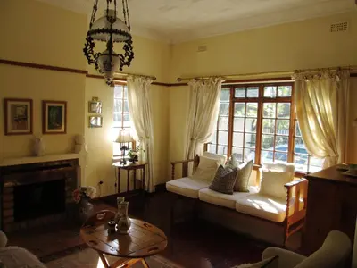 a living room with a couch and a fireplace at Brooks Cottage in Pretoria
