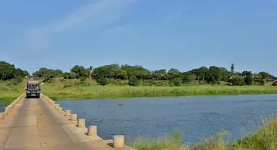 a truck driving on a bridge over a river at Elephant Walk Retreat in Komatipoort