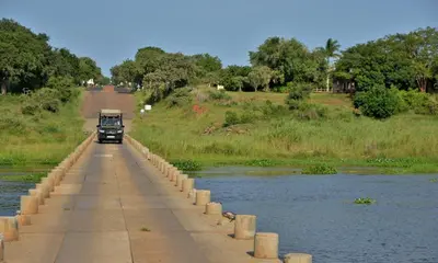 a truck driving on a bridge over a river at Elephant Walk Retreat in Komatipoort