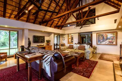 a living room with a couch and a table at Khaya Ndlovu Safari Manor in Hoedspruit