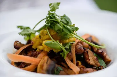 a white bowl of food with meat and vegetables at Khaya Ndlovu Safari Manor in Hoedspruit