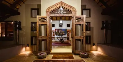 an open door into a room with a table at Khaya Ndlovu Safari Manor in Hoedspruit