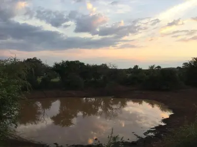 a reflection of the sky in a body of water at Adonsonia Lodge in Grietjie Nature Reserve