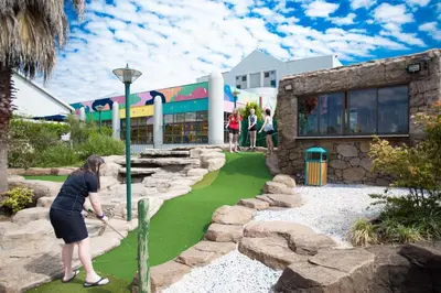 a woman playing golf on a artificial golf course at Umuzi Lodge in Secunda