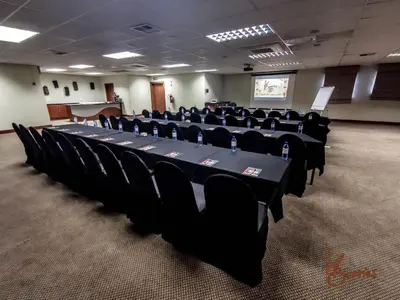 a conference room with a long table and chairs at Umuzi Lodge in Secunda