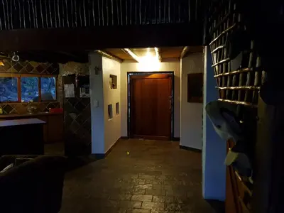 a hallway of a house with a door and a room at Gecko Lodge and Cottage, Mabalingwe in Warmbaths