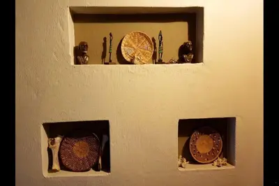 a wall with three plates on a wall at Gecko Lodge and Cottage, Mabalingwe in Warmbaths