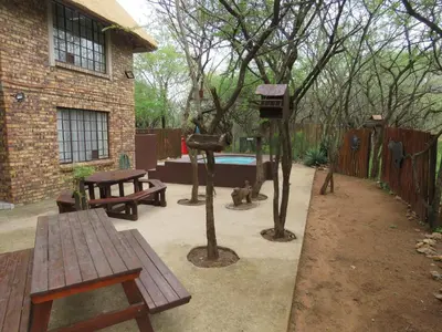 a backyard with a picnic table and a bird feeder at 515 on Warthog by the River in Marloth Park