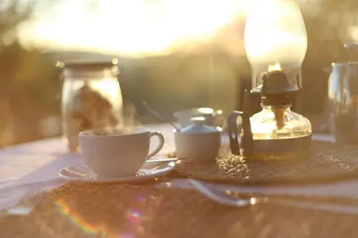 a cup of coffee sitting on top of a table at Ivory Wilderness River Rock Lodge in Klaserie Private Nature Reserve