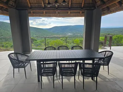 a black table and chairs on a balcony with a view at Bona Kgole Private Game Lodge, Mabalingwe in Warmbaths