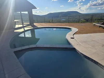 a swimming pool with a view of the mountains at Bona Kgole Private Game Lodge, Mabalingwe in Warmbaths