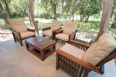 a group of chairs and a coffee table on a patio at Sefapane Lodge and Safaris in Phalaborwa