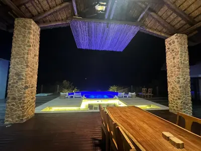 a stage with a table and a purple chandelier at Tebuah Private Lodge, Mabalingwe in Mabula