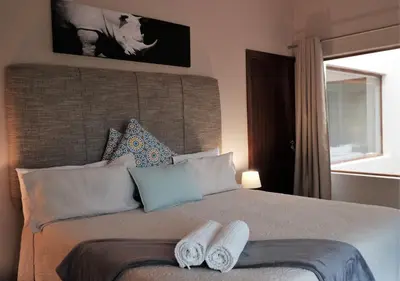 a bedroom with a bed with two towels on it at Goedehoop Boutique Manor House in Malelane