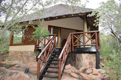 a house with a staircase leading up to it at Sekala Private Game Lodge in Welgevonden Game Reserve