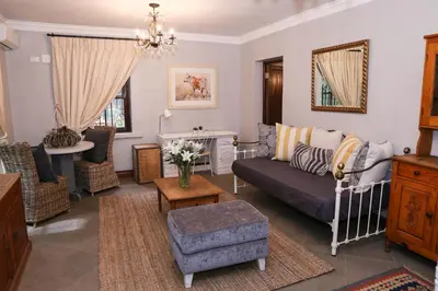 a living room with a couch and a table at Angel Oak guesthouse in Brits