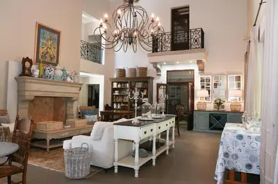 a living room with a fireplace and a chandelier at Angel Oak guesthouse in Brits
