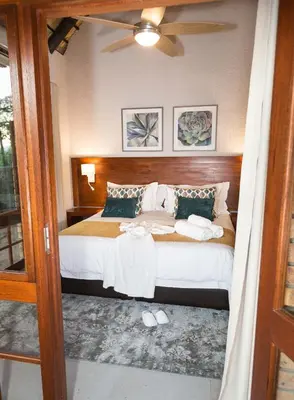 a bedroom with a bed and a ceiling fan at Kruger Park Lodge Unit No. 611 in Hazyview