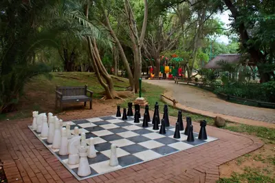 a chess board on a brick path in a park at Kruger Park Lodge Unit No. 611 in Hazyview