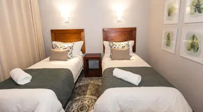 a hotel room with two twin beds in it at Kruger Park Lodge Unit No. 612 in Hazyview