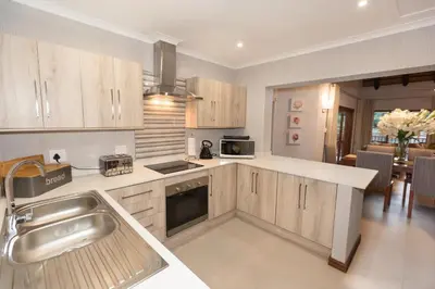 a kitchen with a sink and a stove top oven at Kruger Park Lodge Unit No. 612 in Hazyview