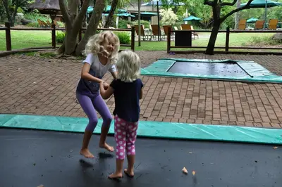 two little girls playing in a trampoline at Kruger Park Lodge Unit No. 612 in Hazyview