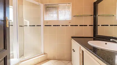 a bathroom with a sink and a shower at See You There Accommodation 2 in Centurion