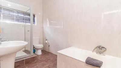 a white bathroom with a sink and a toilet at See You There Accommodation 2 in Centurion