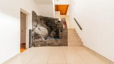 a hallway with stairs and a stone wall at See You There Accommodation 2 in Centurion