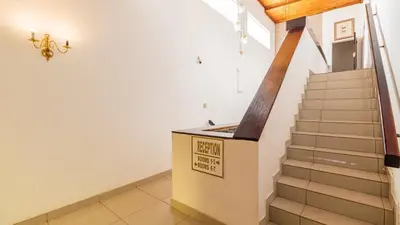 a staircase in a house with a sign on the wall at See You There Accommodation 2 in Centurion