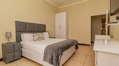 a bedroom with a large bed in a room at See You There Accommodation 1 in Centurion