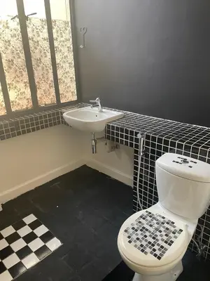 a bathroom with a white toilet and a sink at See You There Accommodation in Centurion